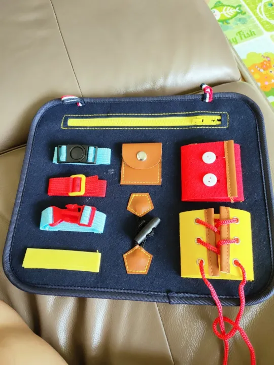 Busy board in the shape of a toy bag to practice skills for babies photo review