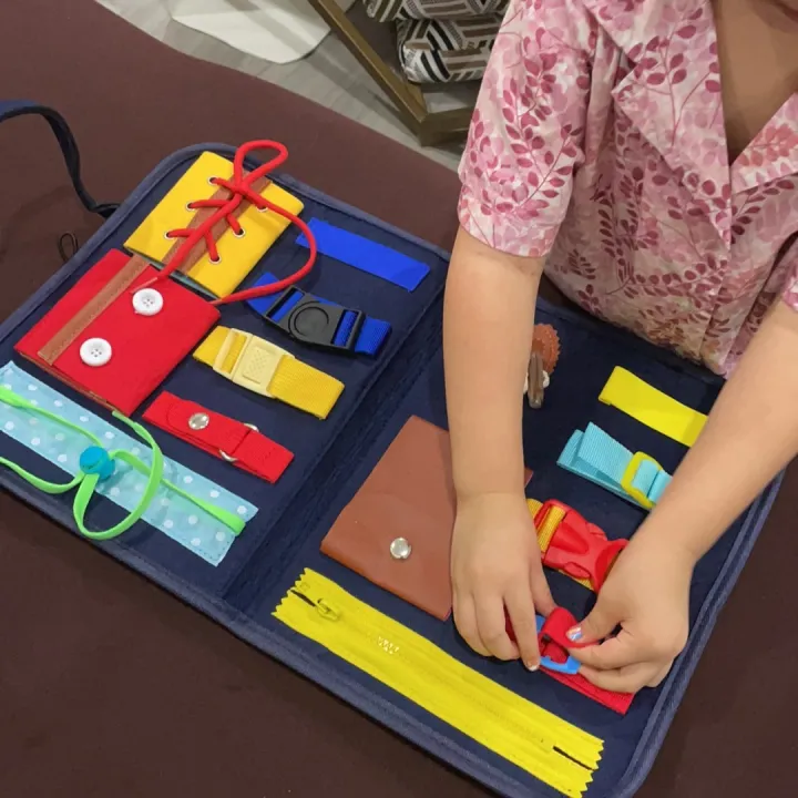 Busy board in the shape of a toy bag to practice skills for babies photo review